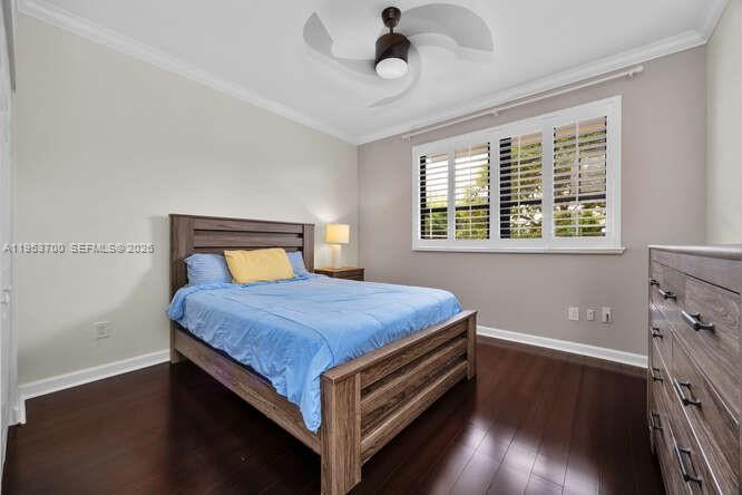 8395 Southwest 73rd Avenue, Unit 104 Miami, FL 33143 - Photo 21 of 35 a bedroom with a bed and wooden floor