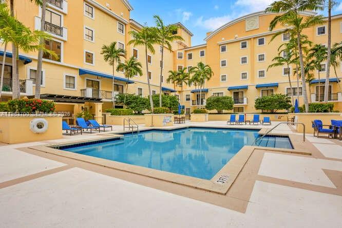 8395 Southwest 73rd Avenue, Unit 104 Miami, FL 33143 - Photo 22 of 35 front view of a building with a swimming pool