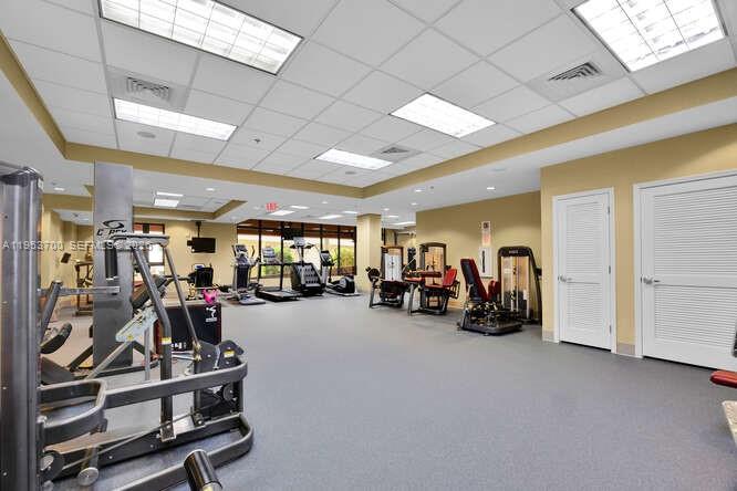 8395 Southwest 73rd Avenue, Unit 104 Miami, FL 33143 - Photo 24 of 35 a view of a room with gym equipment