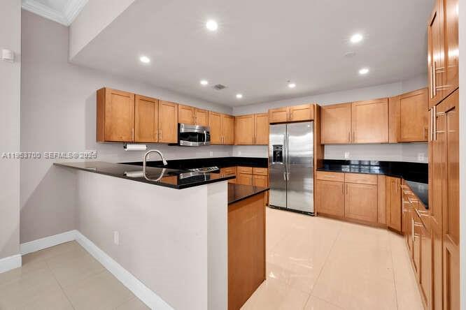 8395 Southwest 73rd Avenue, Unit 104 Miami, FL 33143 - Photo 4 of 35 a kitchen with stainless steel appliances granite countertop a refrigerator and a stove top oven