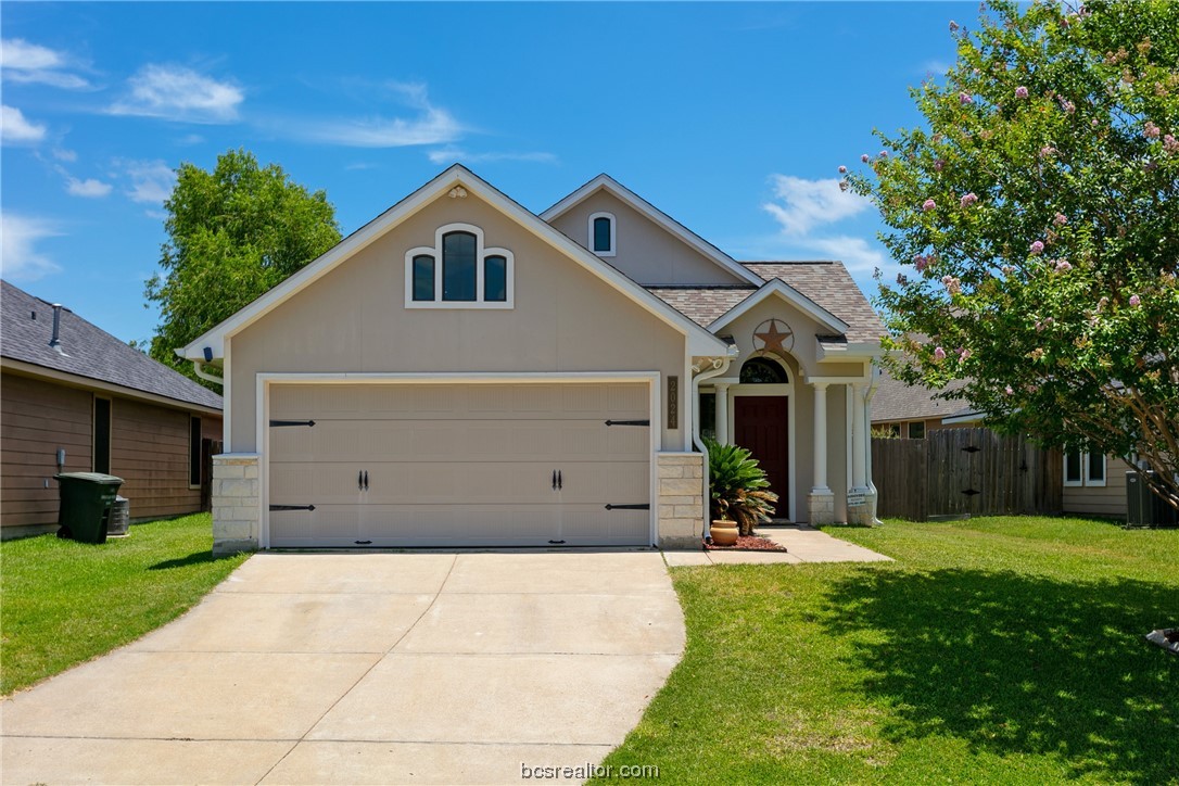 a view of a white house with a big yard and large trees