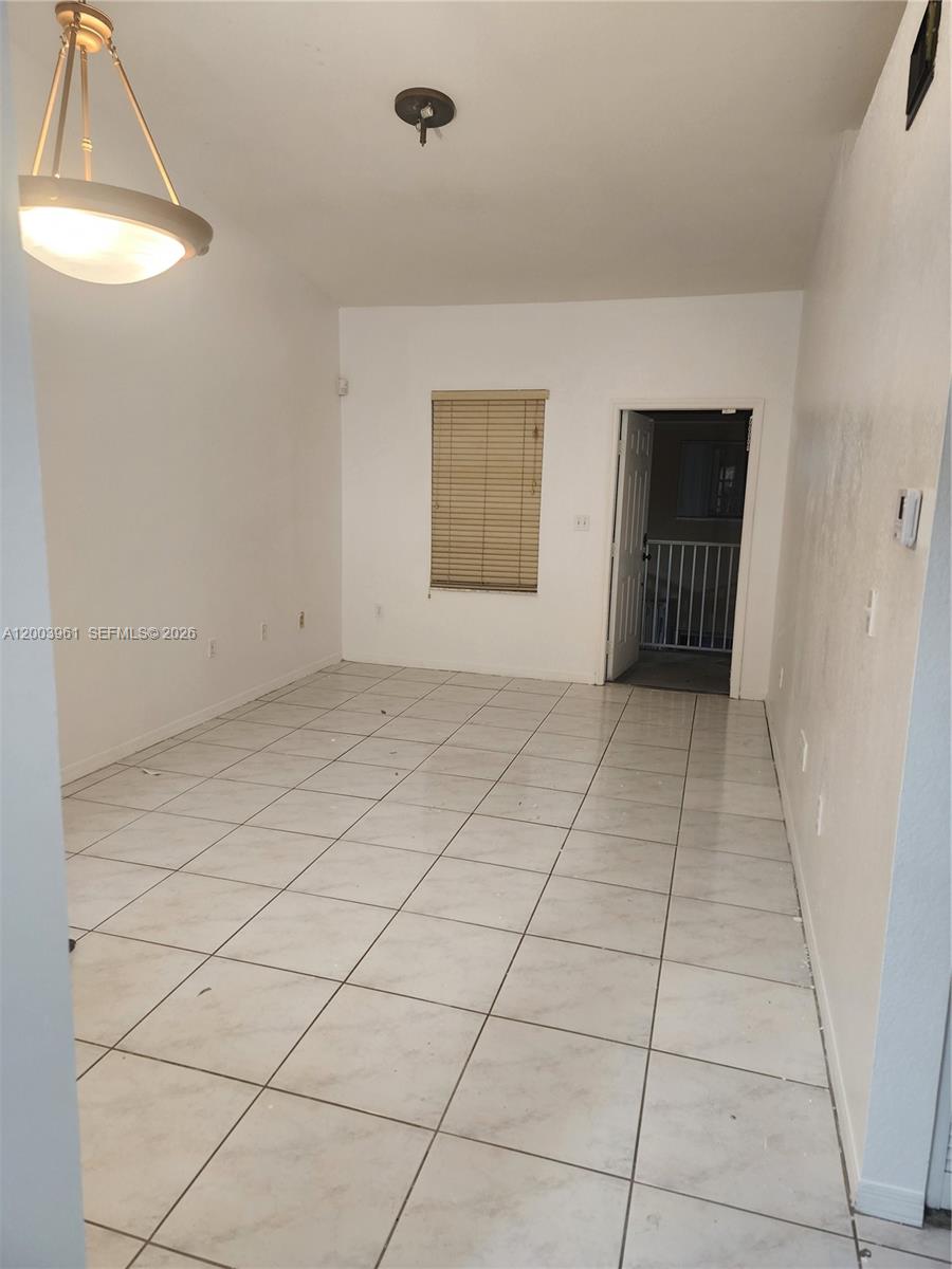 6972 Northwest 179th Street, Unit 2034 Hialeah, FL 33015 - Photo 1 of 10 an empty room with windows