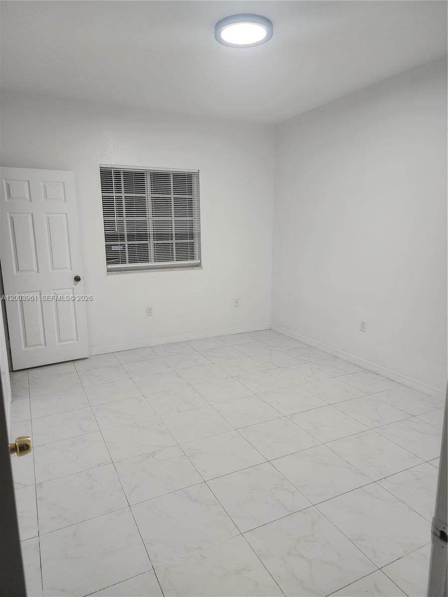 6972 Northwest 179th Street, Unit 2034 Hialeah, FL 33015 - Photo 2 of 10 a view of an empty room with a window