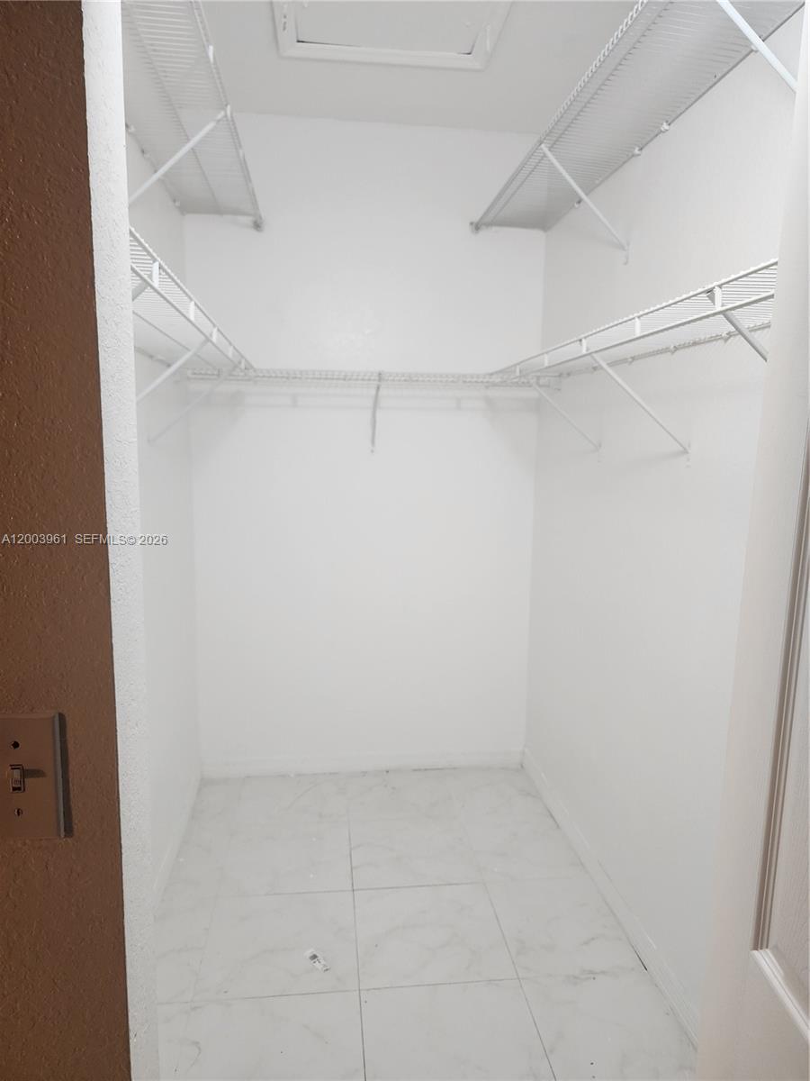 6972 Northwest 179th Street, Unit 2034 Hialeah, FL 33015 - Photo 7 of 10 a view of an empty walk in closet