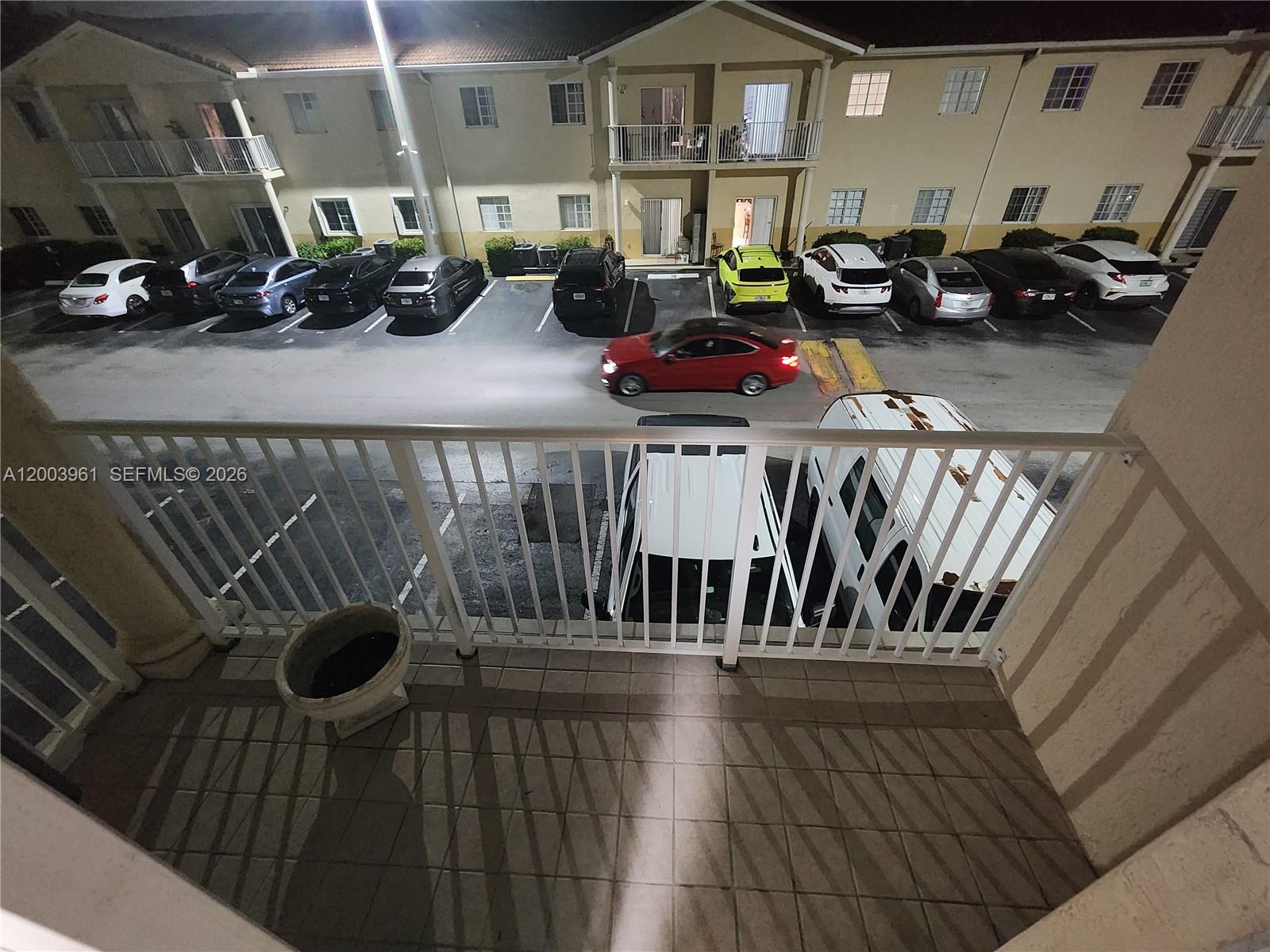 6972 Northwest 179th Street, Unit 2034 Hialeah, FL 33015 - Photo 9 of 10 a view of balcony with cars parked
