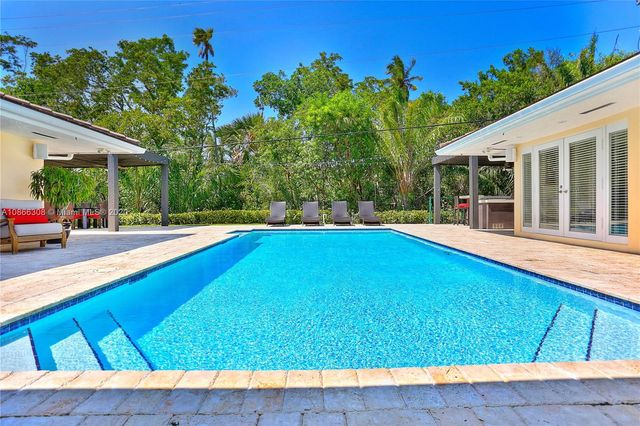 a outdoor space with chairs and a table