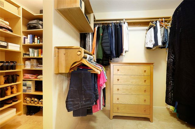 a bedroom with a bed dresser and a window