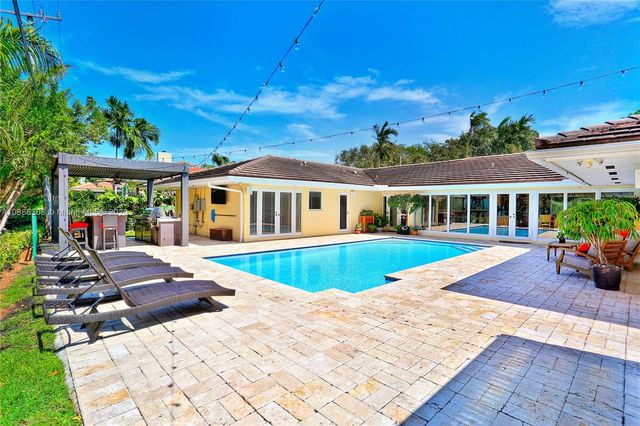 a view of a dining tables and chairs in patio with a barbeque grill