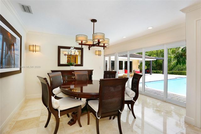 a view of a hallway with living room and dining room