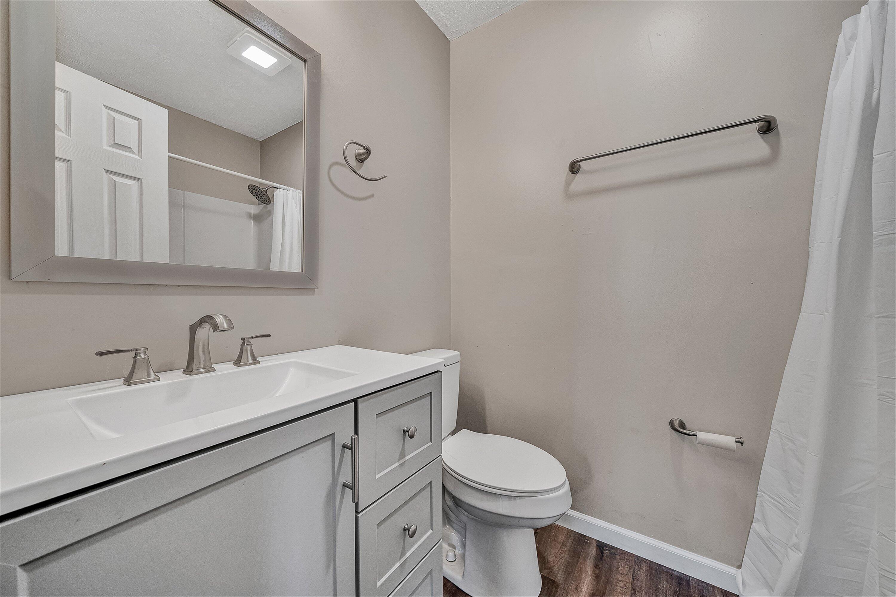 9619 Old Roanoke Road Elliston, VA 24087 - Photo 14 of 29 a bathroom with a granite countertop sink mirror vanity and toilet