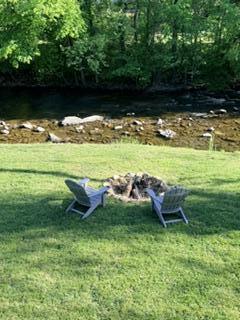 9619 Old Roanoke Road Elliston, VA 24087 - Photo 21 of 29 a view of a lake with a bench and trees in the background