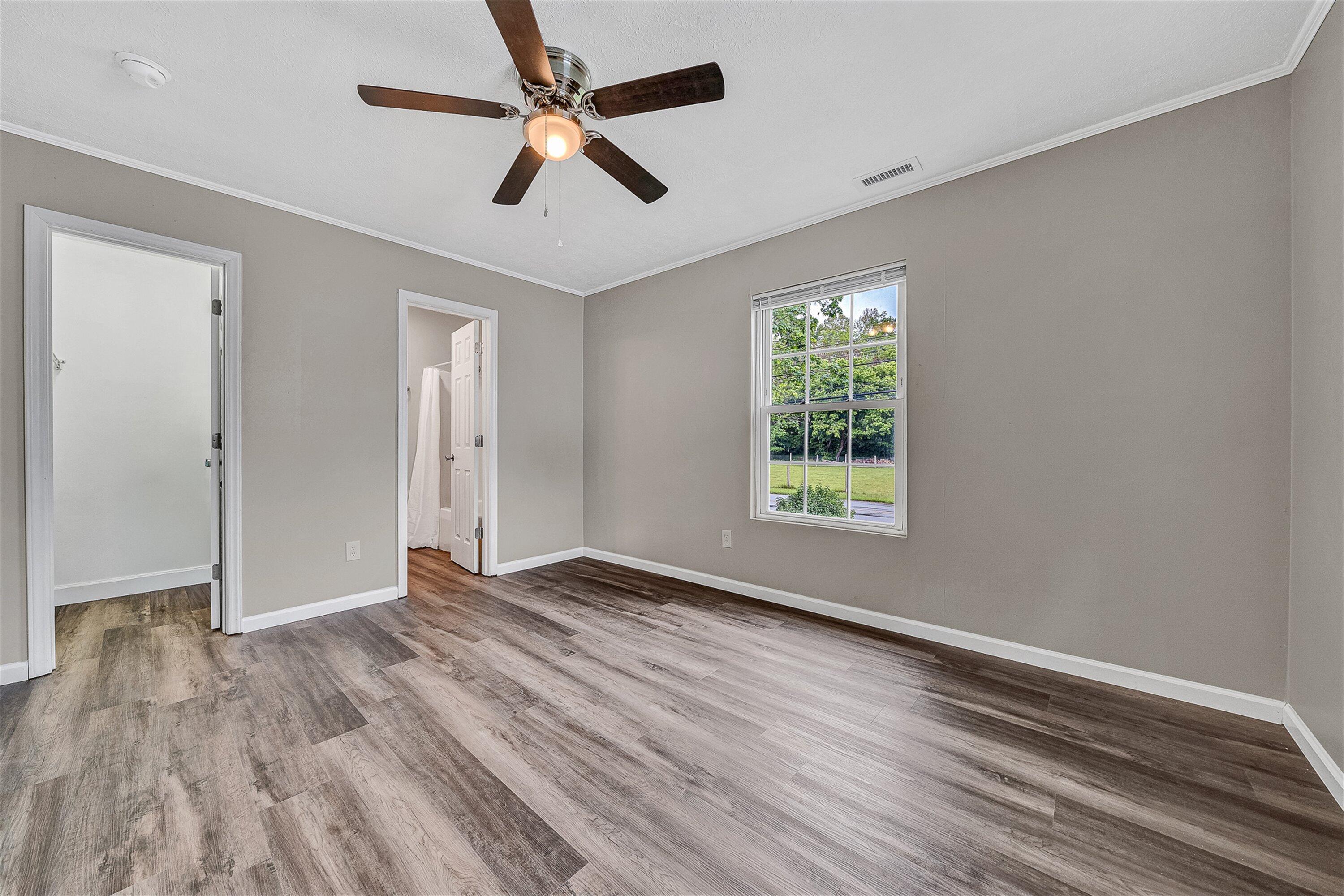 9619 Old Roanoke Road Elliston, VA 24087 - Photo 10 of 29 a view of empty room with wooden floor and fan
