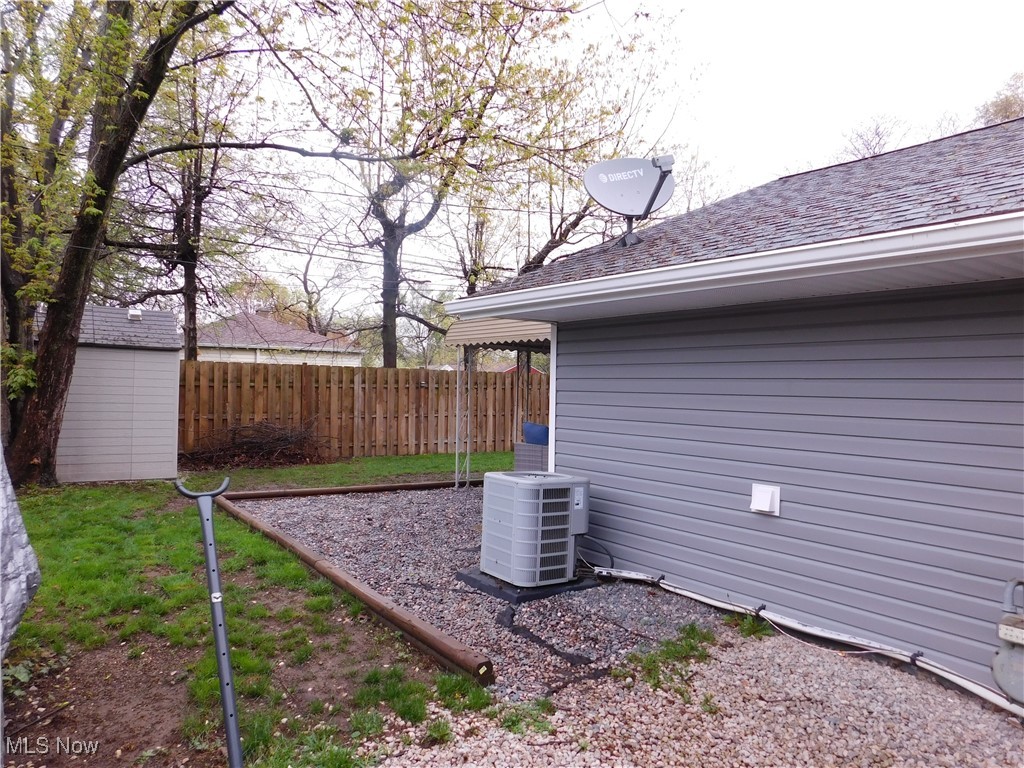 9720 West Ridgewood Drive Parma Heights, OH 44130 - Photo 44 of 46 View of yard featuring fence, an outdoor structure, and central air condition unit