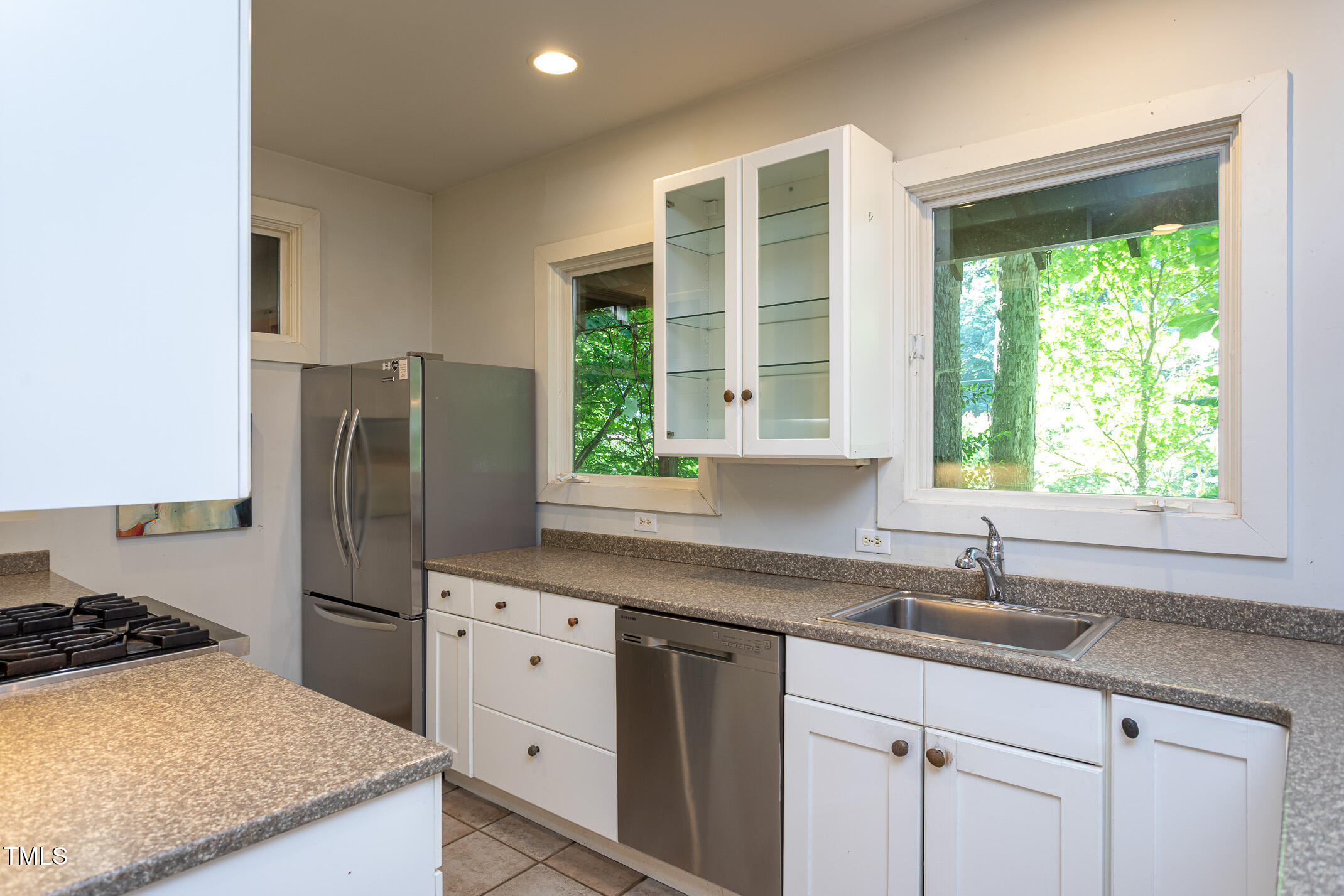 820 Runnymede Road Raleigh, NC 27607 - Photo 14 of 43 a kitchen with white cabinets and a window