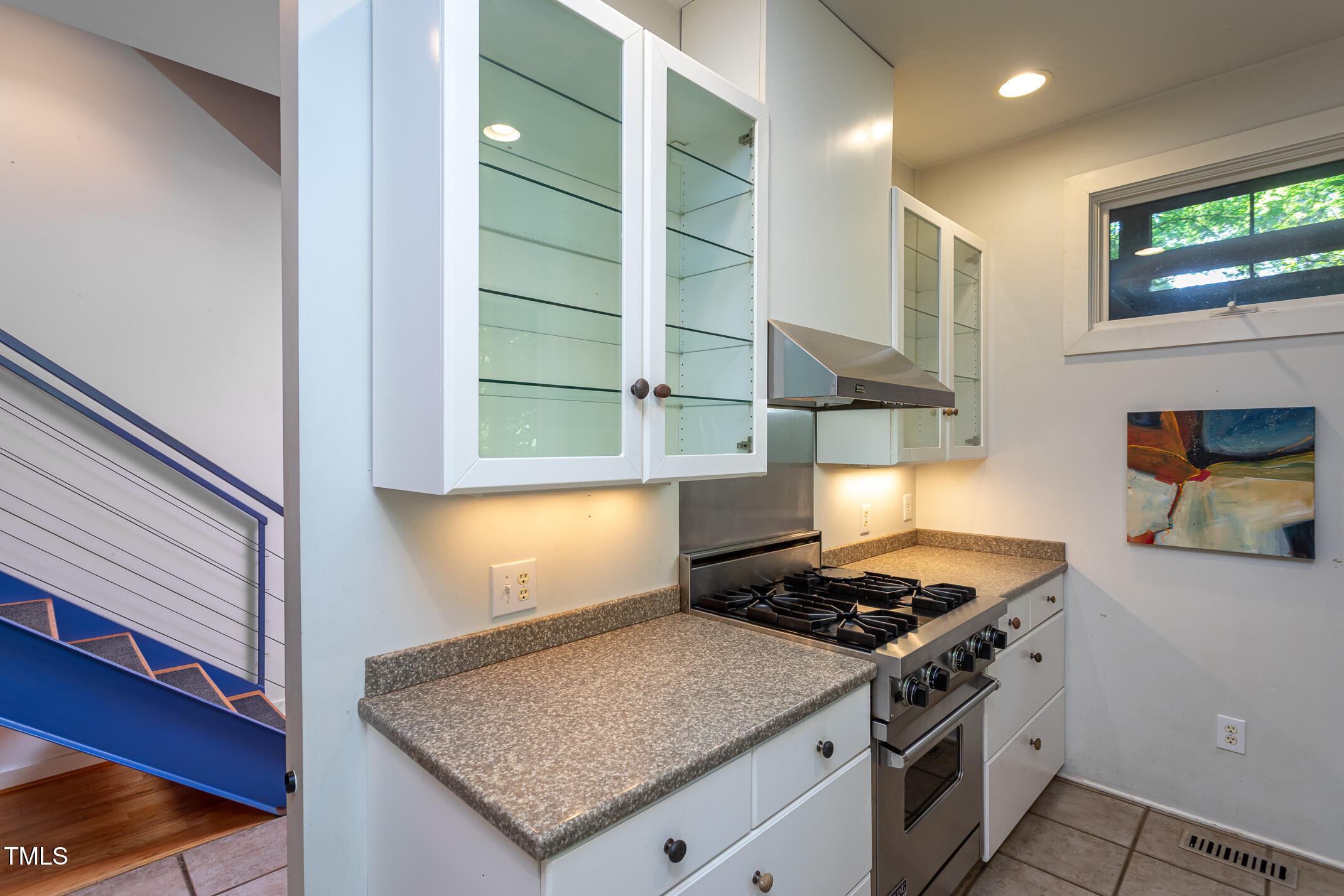 820 Runnymede Road Raleigh, NC 27607 - Photo 15 of 43 a kitchen with stainless steel appliances granite countertop a stove a sink and a microwave