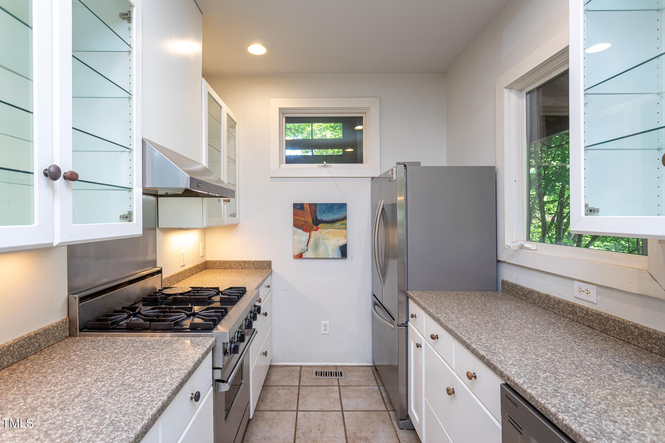 820 Runnymede Road Raleigh, NC 27607 - Photo 16 of 43 a kitchen with stainless steel appliances granite countertop a stove a refrigerator and a sink