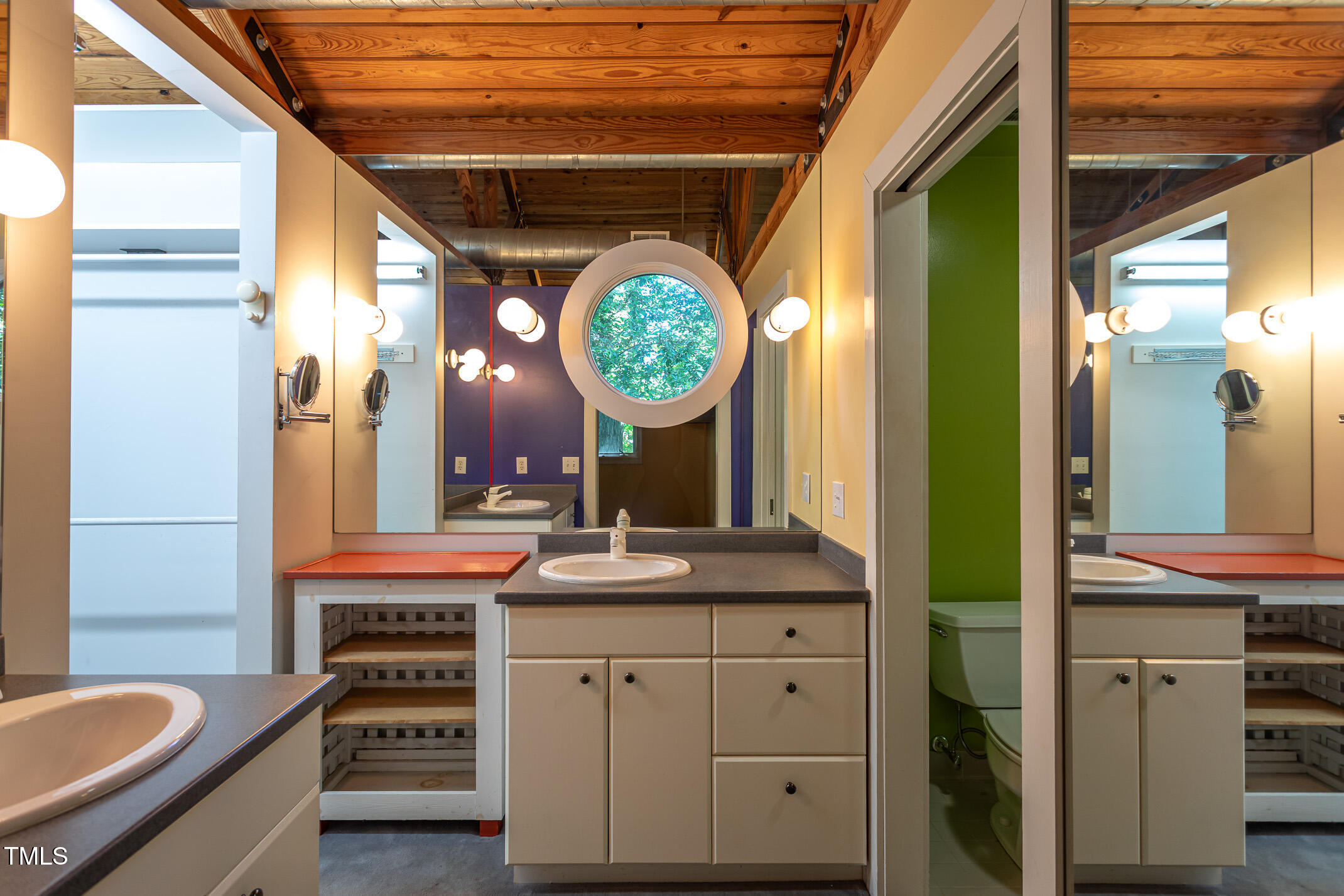 820 Runnymede Road Raleigh, NC 27607 - Photo 25 of 43 a bathroom with a sink a mirror and a shower