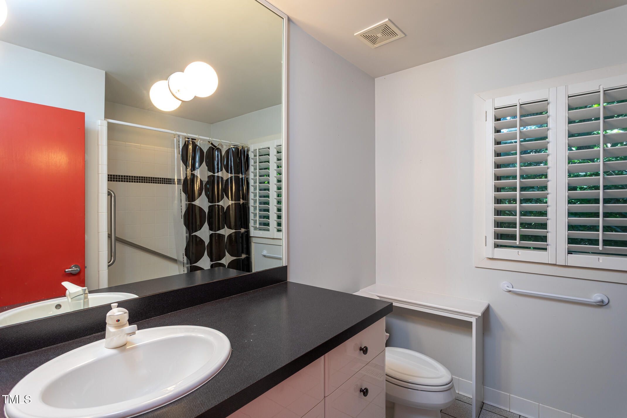 820 Runnymede Road Raleigh, NC 27607 - Photo 29 of 43 a bathroom with a granite countertop sink toilet and mirror