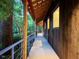 820 Runnymede Road Raleigh, NC 27607 - Photo 4 of 43 a view of balcony with wooden floor and fence