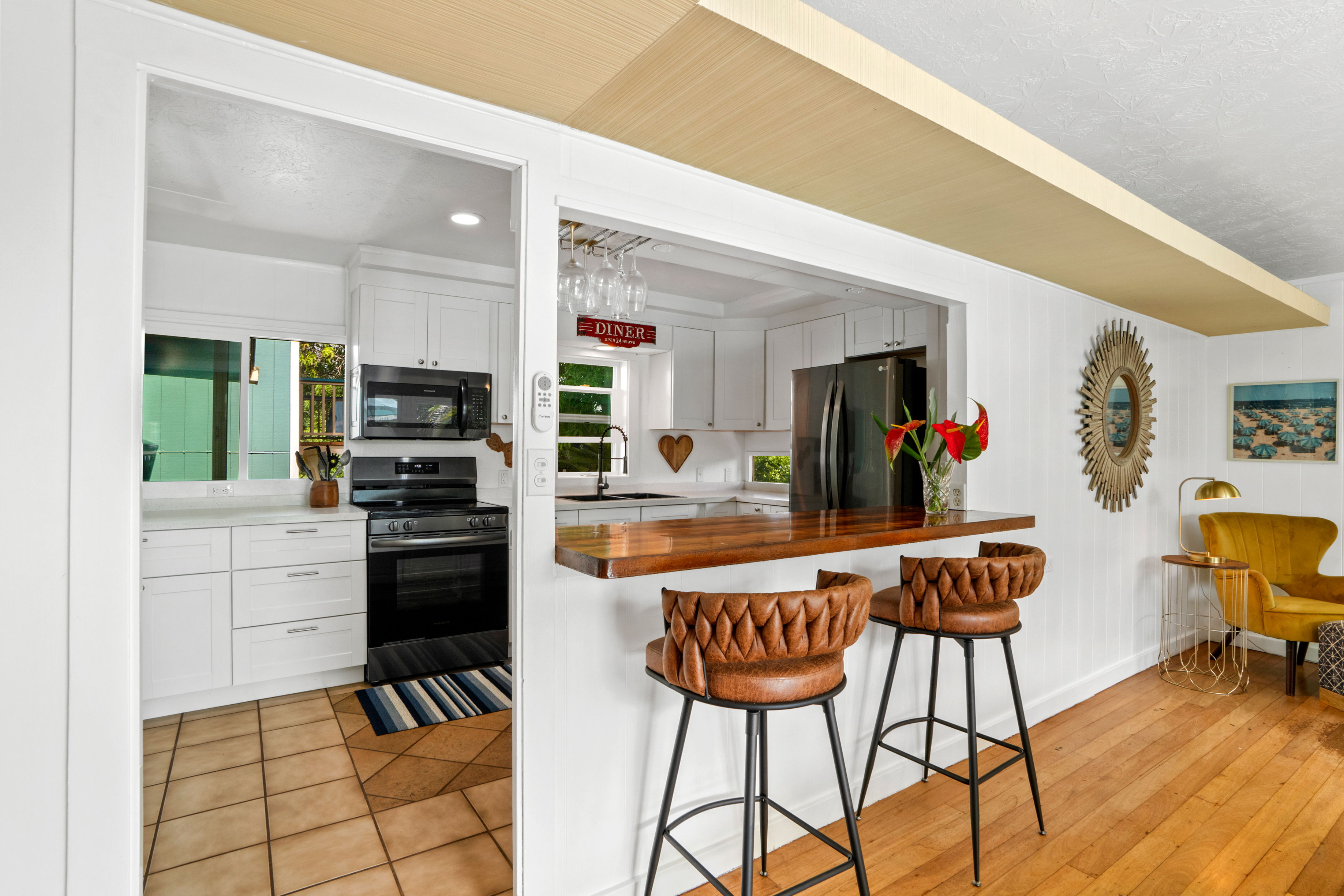 4885 Laipo Road Kapaa, HI 96746 - Photo 4 of 28 a kitchen with stainless steel appliances kitchen island granite countertop a refrigerator and a stove top oven