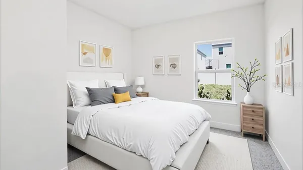 a bedroom with a bed plant and cabinets