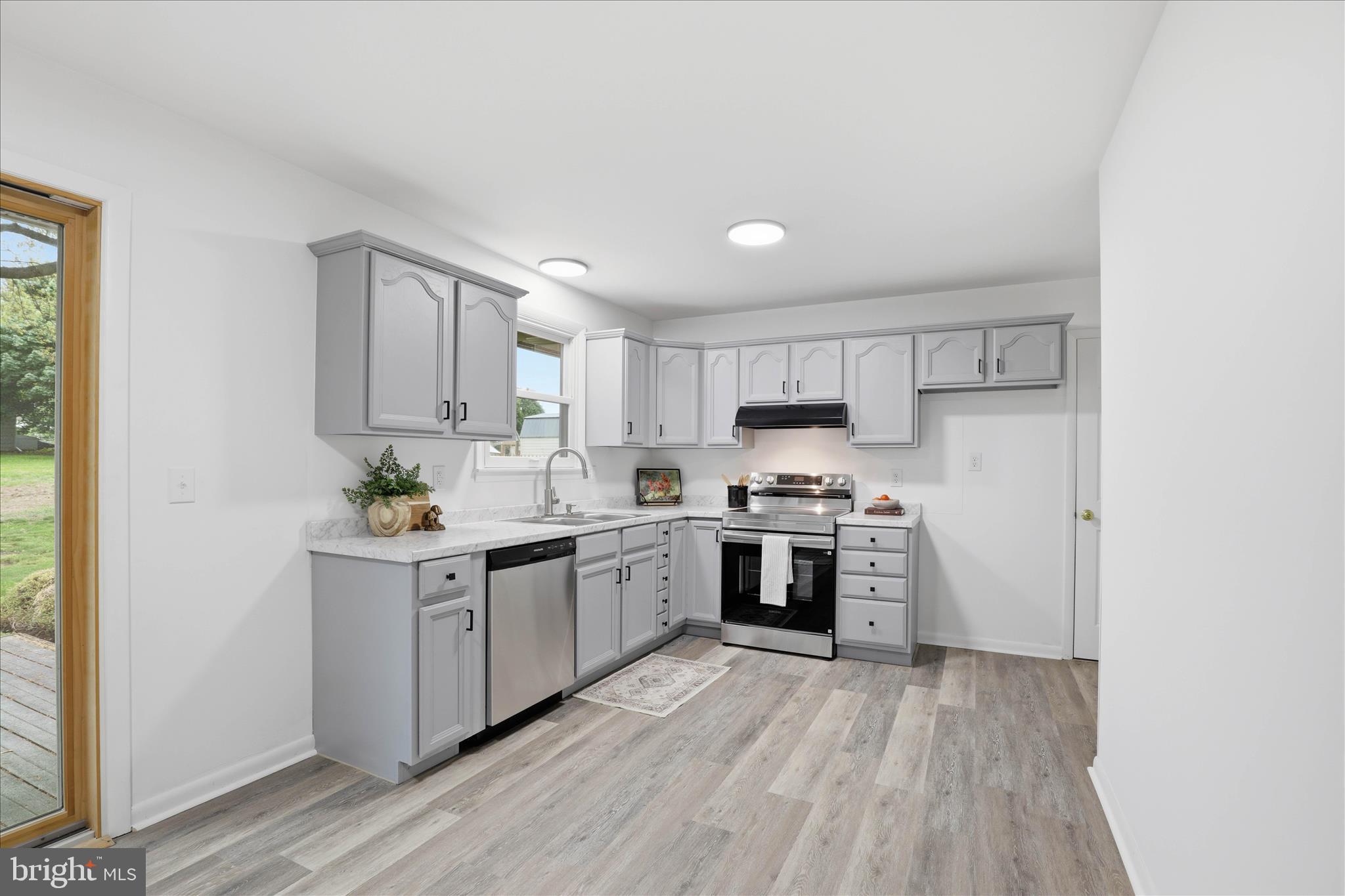 947 Hill Street Manheim, PA 17545 - Photo 12 of 47 a kitchen with stainless steel appliances granite countertop a stove top oven a sink dishwasher and a refrigerator with wooden floor