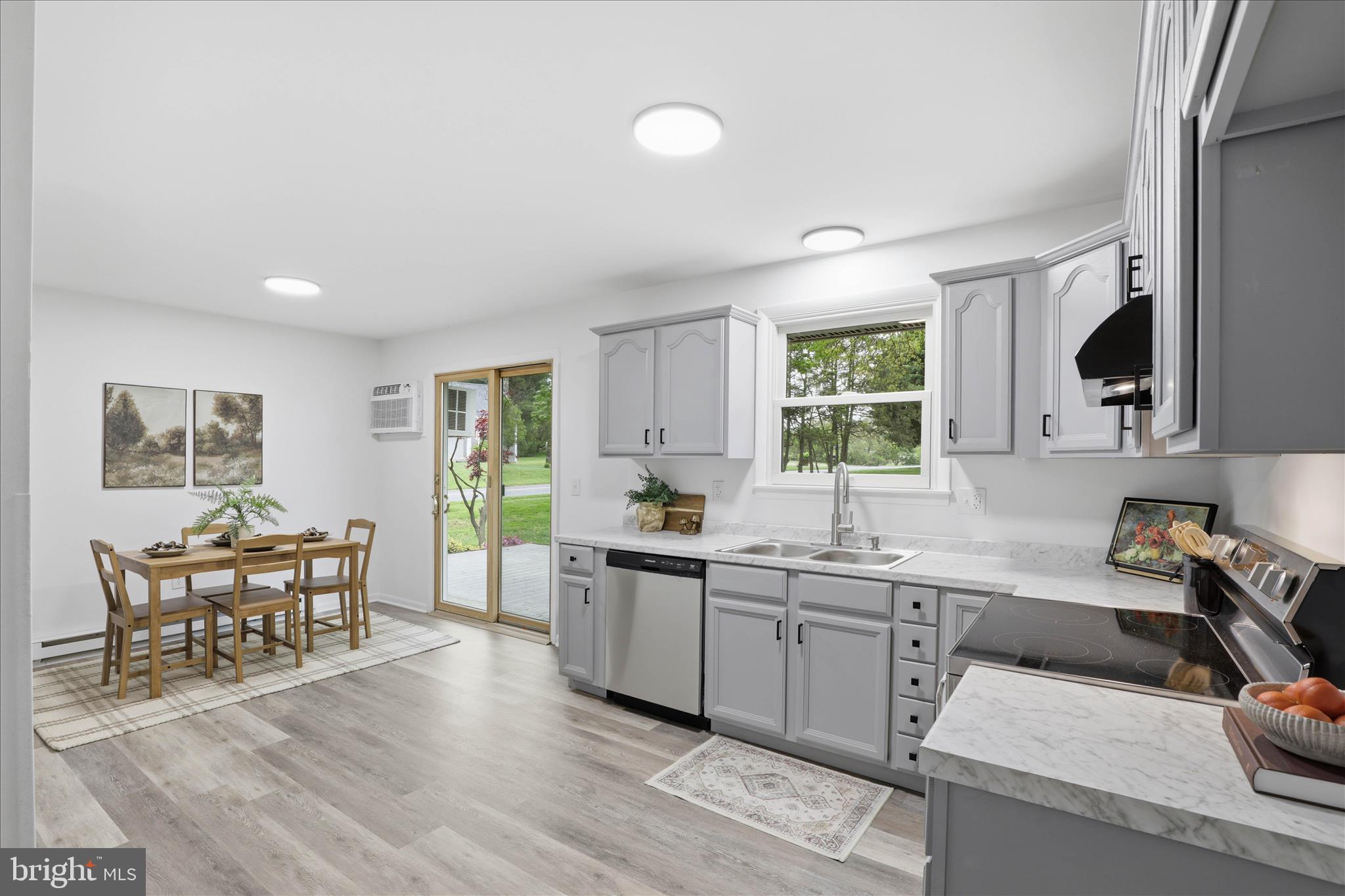947 Hill Street Manheim, PA 17545 - Photo 15 of 47 a kitchen with a sink a stove a dining table and chairs