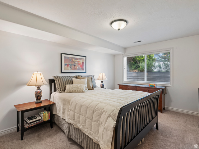 11881 Cottage View Lane Draper, UT 84020 - Photo 17 of 29 Carpeted room featuring a large window with blinds, white walls, and a ceiling-mounted light fixture