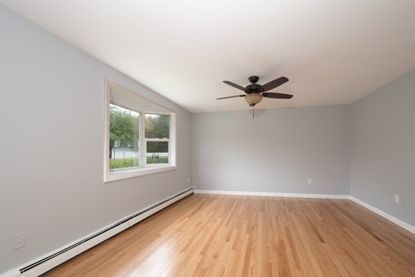 9 Autumn Way Pembroke, MA 02359 - Photo 12 of 42 an empty room with wooden floor fan and windows
