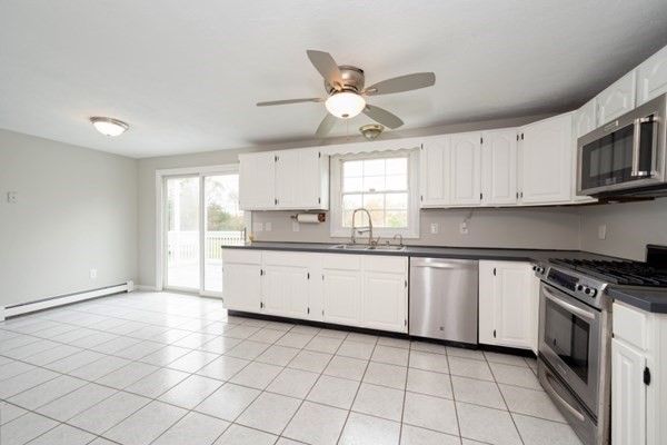 9 Autumn Way Pembroke, MA 02359 - Photo 13 of 42 a kitchen with a stove a sink and a microwave