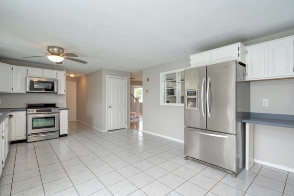 9 Autumn Way Pembroke, MA 02359 - Photo 14 of 42 a kitchen with stainless steel appliances a refrigerator and a stove top oven