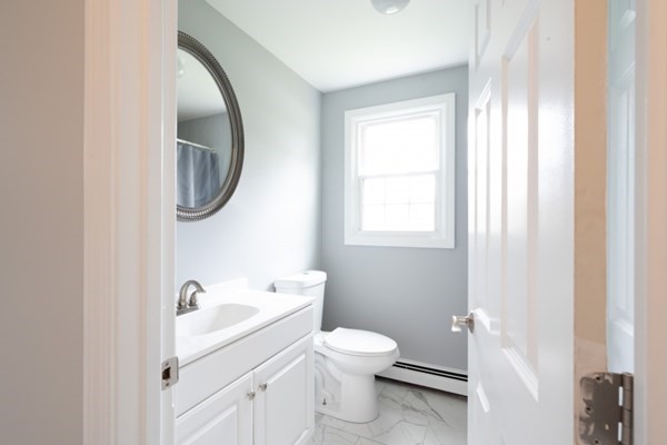 9 Autumn Way Pembroke, MA 02359 - Photo 16 of 42 a white toilet sitting next to a bathroom sink