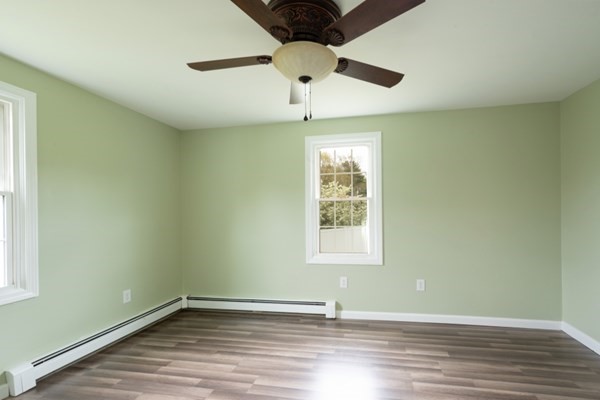 9 Autumn Way Pembroke, MA 02359 - Photo 17 of 42 an empty room with wooden floor chandelier fan and windows