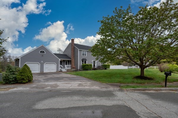 9 Autumn Way Pembroke, MA 02359 - Photo 2 of 42 a front view of a house with a yard and garage