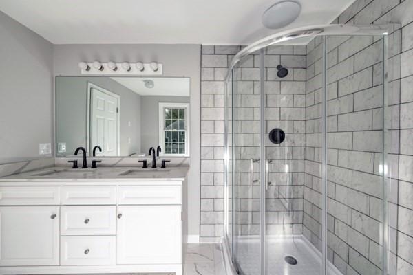 9 Autumn Way Pembroke, MA 02359 - Photo 29 of 42 a bathroom with a granite countertop sink a mirror and shower