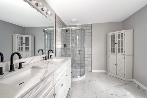 9 Autumn Way Pembroke, MA 02359 - Photo 30 of 42 a bathroom with a double vanity sink a mirror and a shower