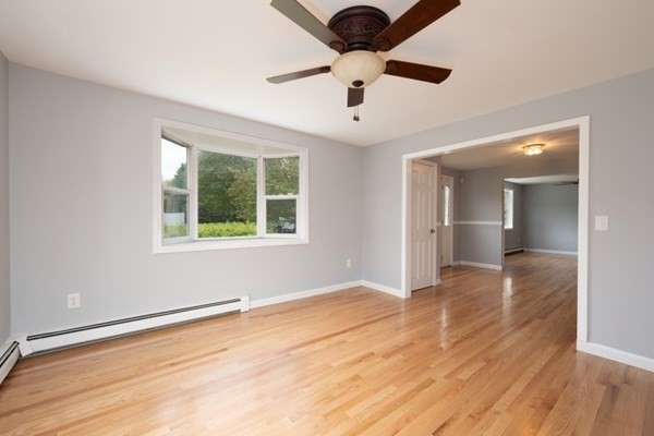 9 Autumn Way Pembroke, MA 02359 - Photo 9 of 42 an empty room with wooden floor chandelier and windows