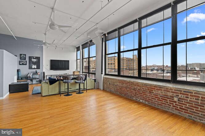314 North 12th Street, Unit 1004 Philadelphia, PA 19107 - Photo 7 of 16 a living room with furniture floor to ceiling window and a flat screen tv