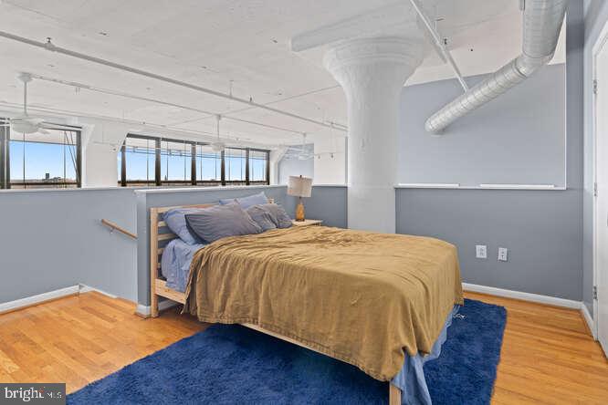314 North 12th Street, Unit 1004 Philadelphia, PA 19107 - Photo 10 of 16 a bed sitting in a bedroom next to a window