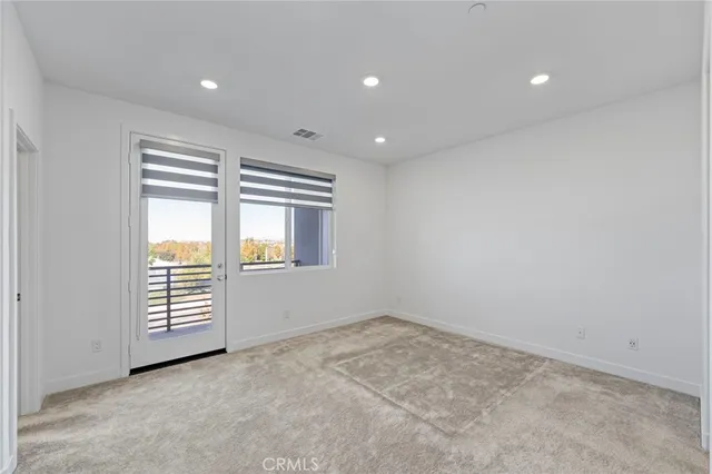 an empty room with closet and a bathroom