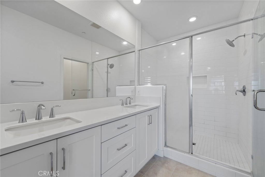 398 Merit Irvine, CA 92618 - Photo 27 of 55 a bathroom with a shower sink and mirror