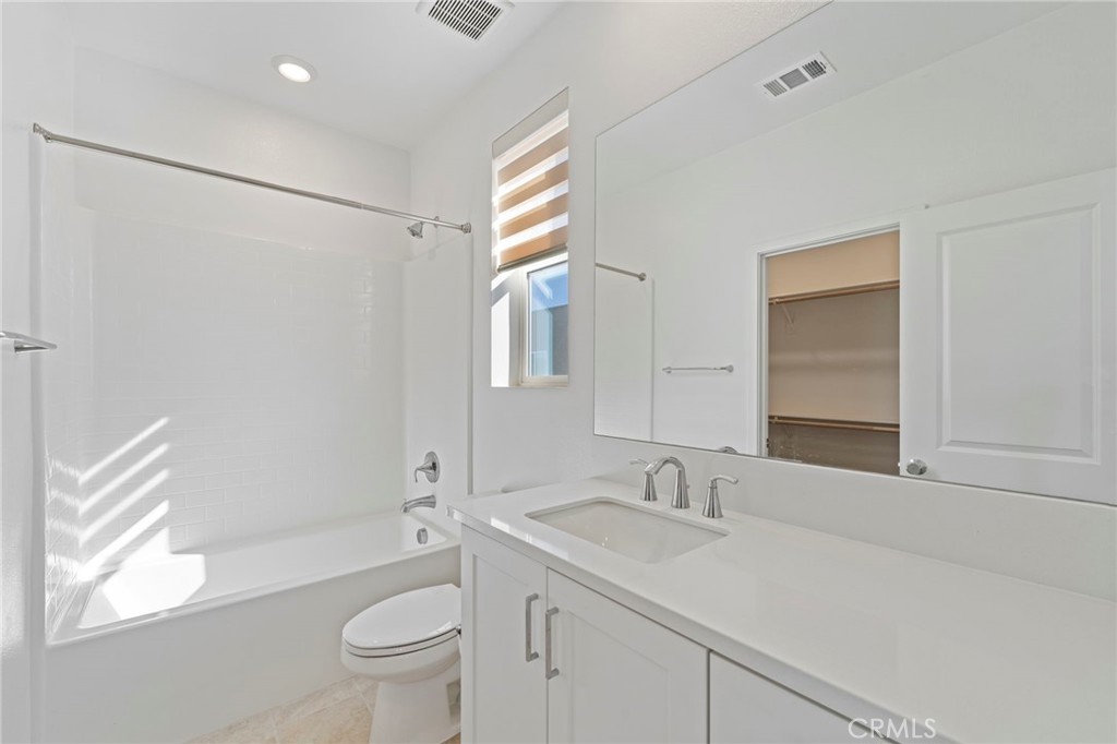 398 Merit Irvine, CA 92618 - Photo 32 of 55 a bathroom with a granite countertop sink toilet and shower