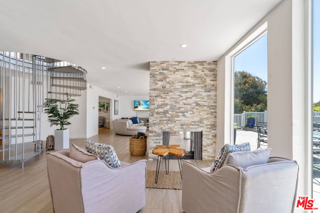 31518 Broad Beach Road Malibu, CA 90265 - Photo 12 of 27 a living room with fireplace furniture and a large window