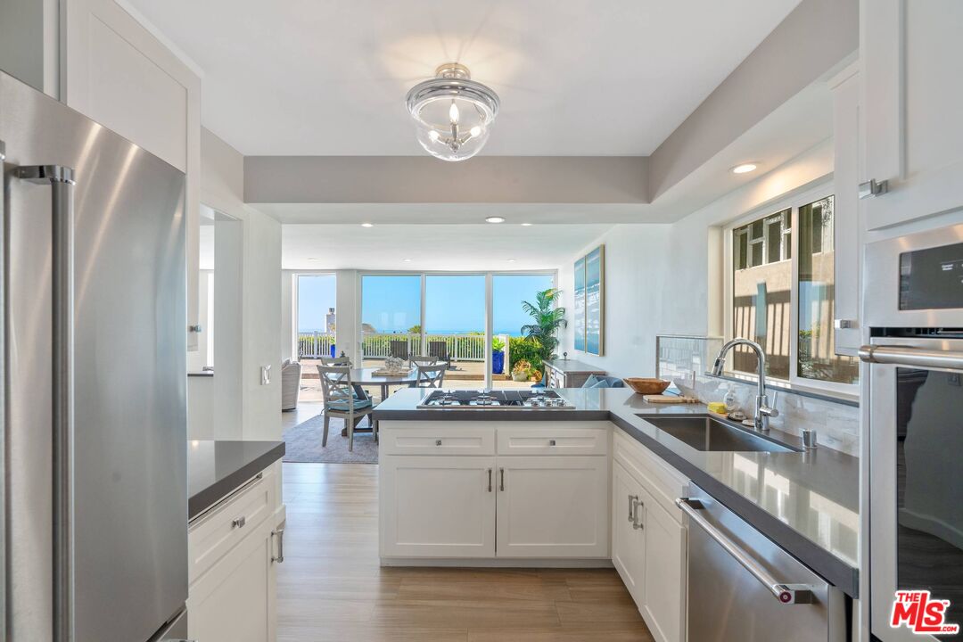 31518 Broad Beach Road Malibu, CA 90265 - Photo 13 of 27 a kitchen with stainless steel appliances granite countertop a sink stove and refrigerator