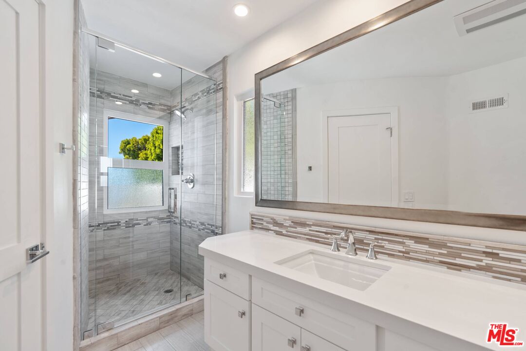 31518 Broad Beach Road Malibu, CA 90265 - Photo 17 of 27 a bathroom with a shower sink and mirror