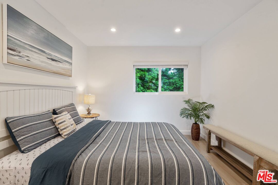31518 Broad Beach Road Malibu, CA 90265 - Photo 19 of 27 a bedroom with a bed and a potted plant