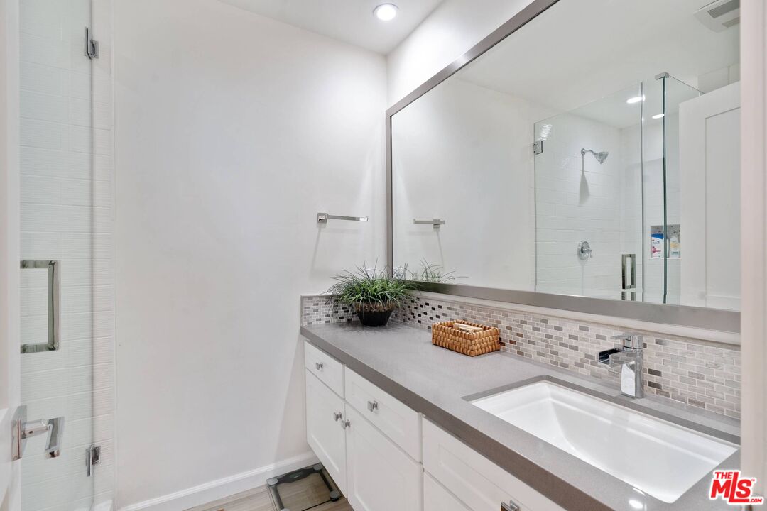 31518 Broad Beach Road Malibu, CA 90265 - Photo 22 of 27 a bathroom with a granite countertop sink and a mirror