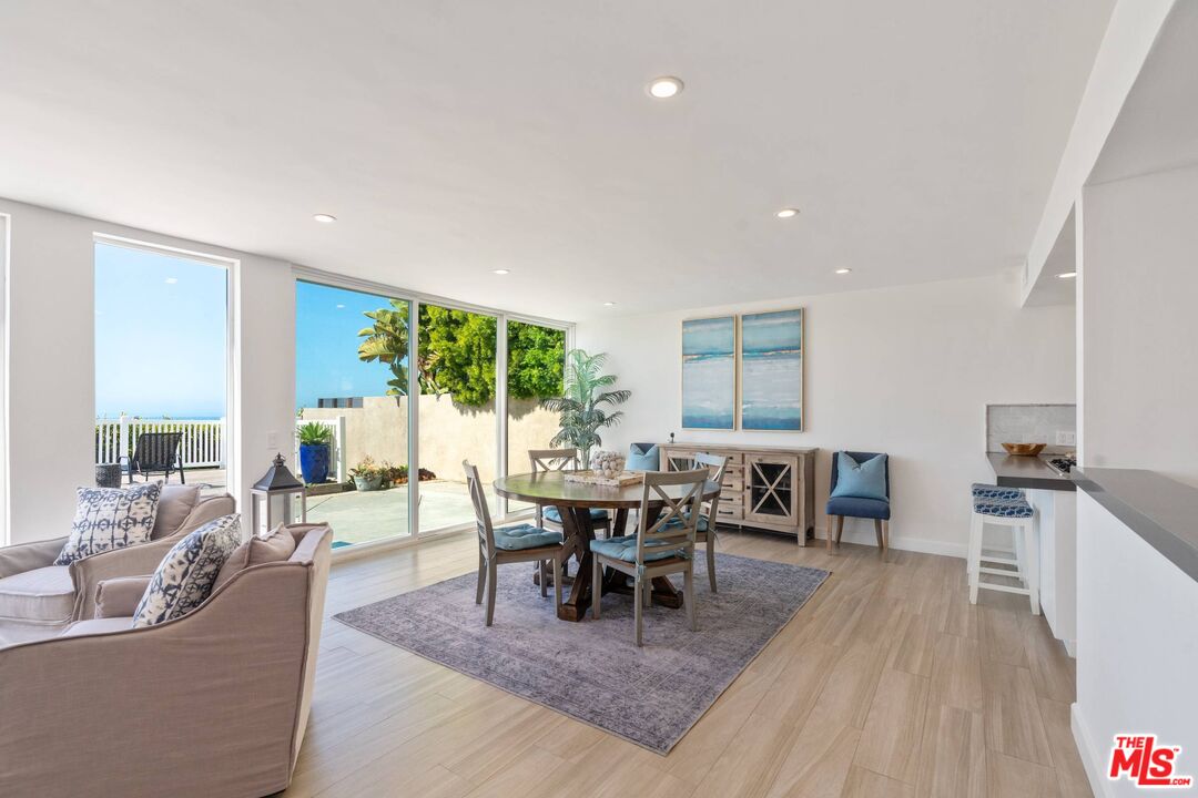 31518 Broad Beach Road Malibu, CA 90265 - Photo 7 of 27 a living room with furniture a dining table and a large window