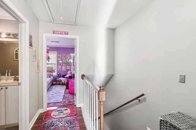a hallway with a flower pot next to a window
