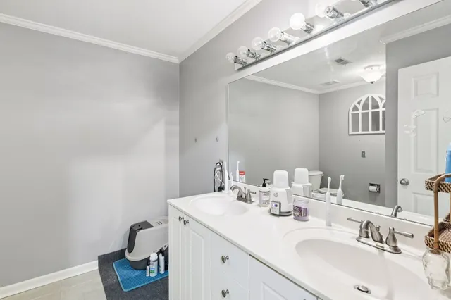 a bathroom with a sink vanity and a mirror